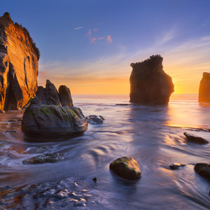 Three Sisters, North Island, NZ. Two exposures were required &ndash; one for water motion and one for all other elements. The sun was obscured by the rock to give a flare effect, and tripod had to be elevated on sturdy rocks. Image by Marianne Lim.